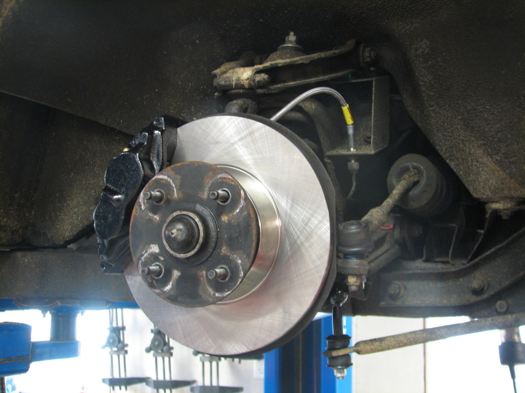 Toyota Caliper mounted with new rotor and stainless brake line.