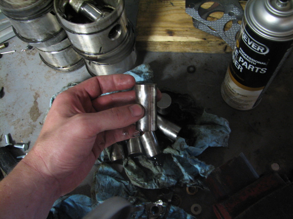 I couldn't get a shot with the camera to show the wear on these tappets.  However, if you saw it live, you would immediately recognize the dished appearance of the tappet to be a problem.  If you don't look at flat tappets frequently, you would at least ask, "Say, is that dished out shape on the top of that tappet normal?"  No, it's not normal at all.  For that exact reason (tappet wear on old style flat tappets), we use oil with Zinc (ZDDP additive) when we do oil changes on these old cars.  Most newer cars have roller tappets and the zinc is not an issue.  New oil standards do not have as much zinc in them because newer engines don't need zinc.  